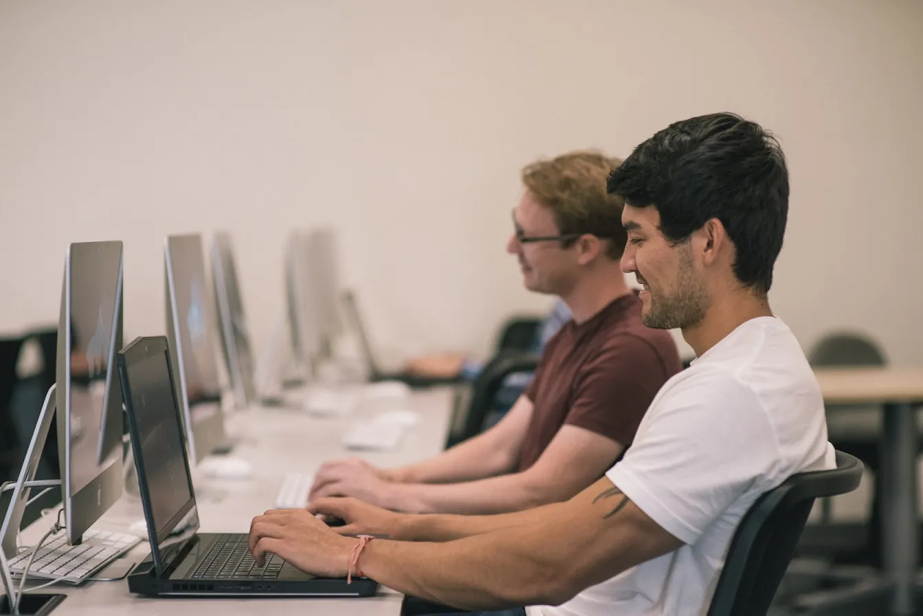 Image of students working on a computer.