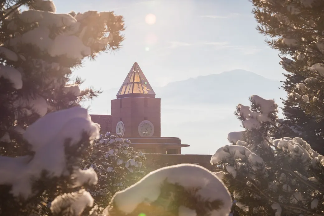 Photo of the UCCS clock tower during the sunset.