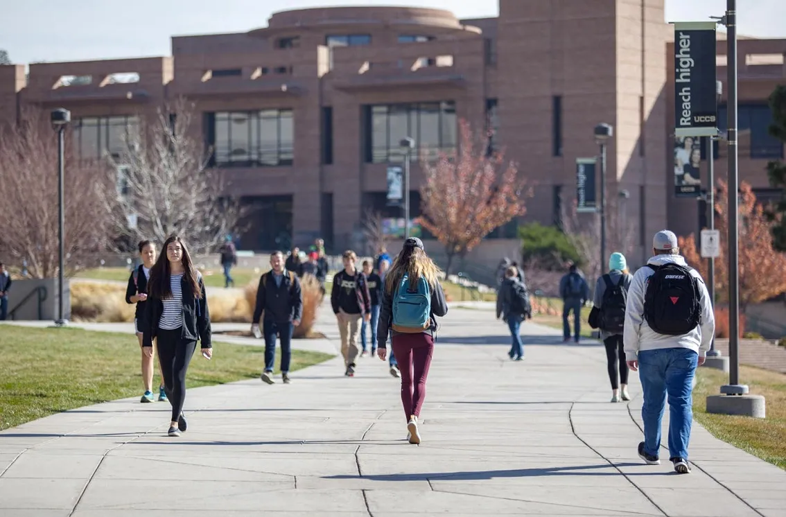 Groups of UCCS students walking around campus.