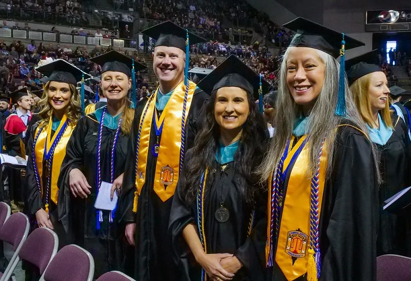 Students smile at commencement