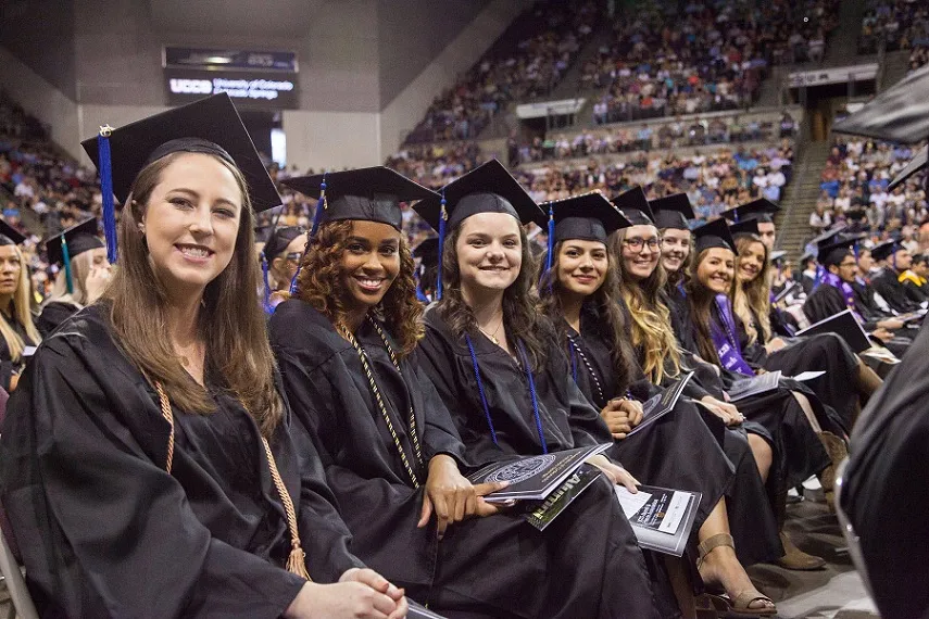 Students smile at commencement