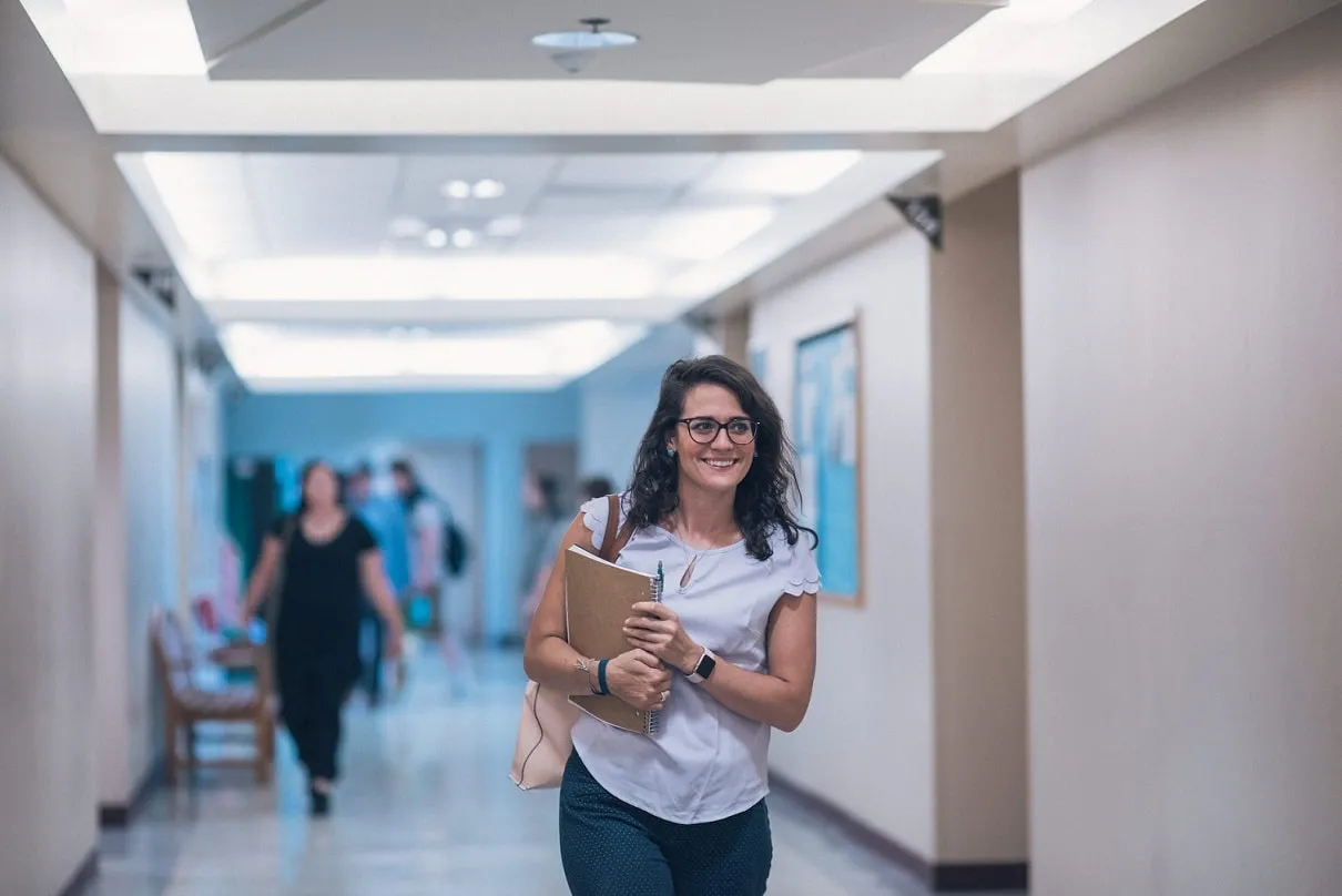 UCCS student walking through a hallway.