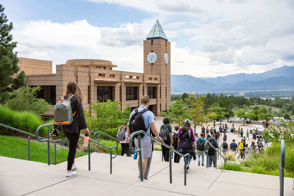 students walking on campus in front of the El Pomar Center